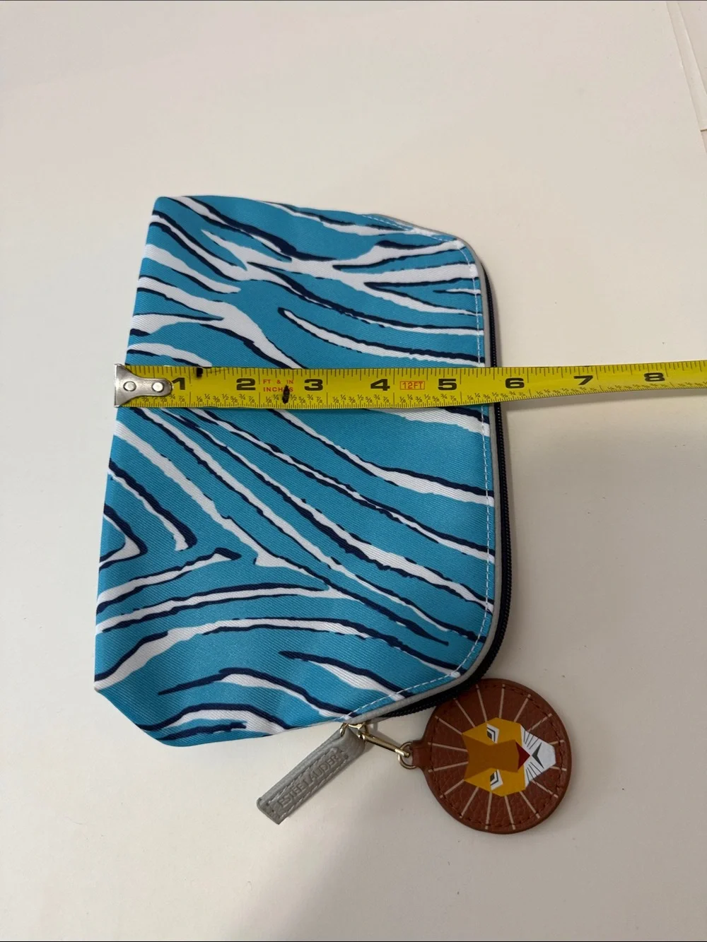 Estee Lauder Turquoise and White Zebra-Print Cosmetic Pouch with Lion Charm